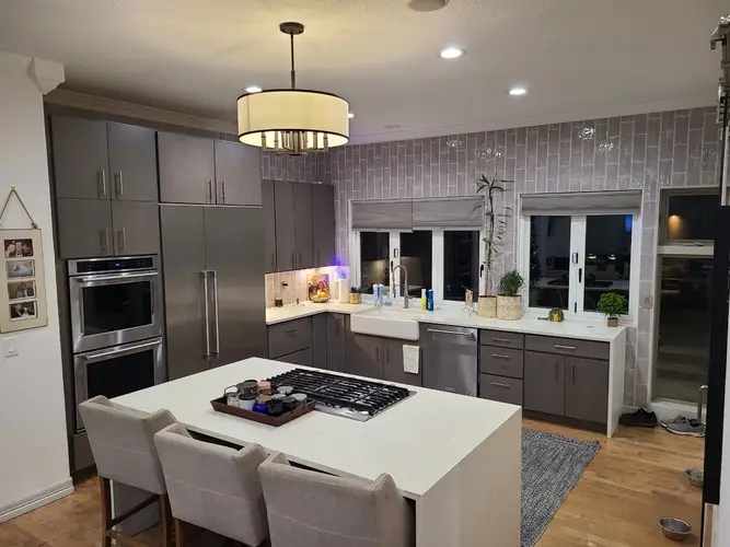 Modern kitchen cabinetry in Arvada with sleek white shaker cabinets and stainless steel hardware